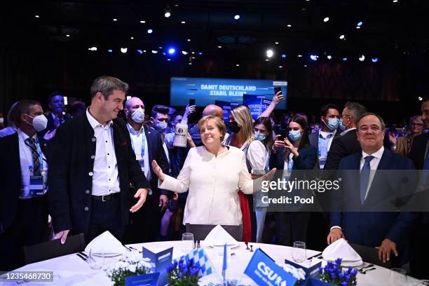 Christian Social Union chairman Markus Soeder, German Chancellor Angela Merkel and Christian Democratic Union party chairman and top candidate for...