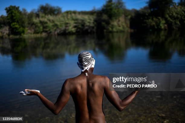 Haitian migrant bathes at the Rio Grande river, in Ciudad Acuna, Coahuila state, Mexico on September 24, 2021.