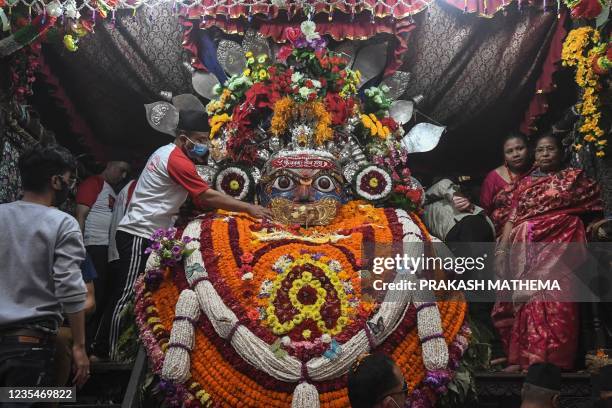 Hindu worship the idol of the Hindu deity Akasah Bhairab on the last day of the Indra Jatra Festival in Kathmandu on September 24, 2021.