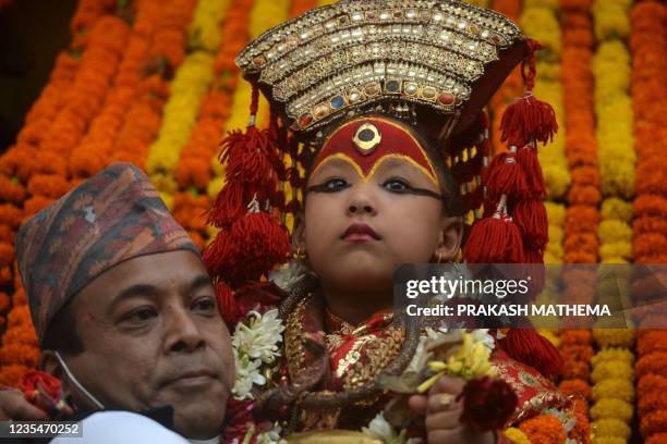 Girl child revered as a living goddess or Kumari is carried in a chariot during a procession on the last day of the Indra Jatra festival at...