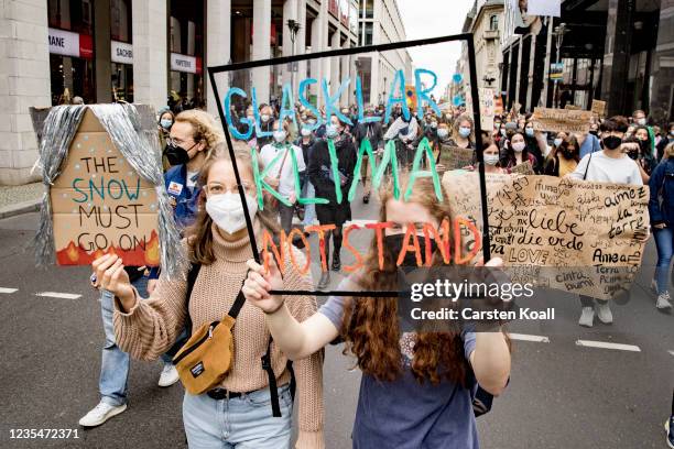 Children hold signs during a large-scale climate strike march by Fridays for Future on September 24, 2021 in Berlin, Germany. Germany is to hold...