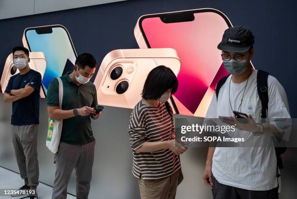 Shoppers queue at an Apple store during the launch day of the new iPhone 13 series smartphones in Hong Kong.