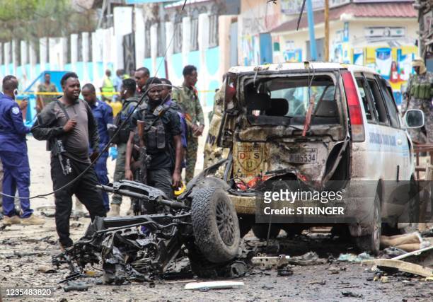 Security officers patrol on the site of a car-bomb attack in Mogadishu, on September 25, 2021.