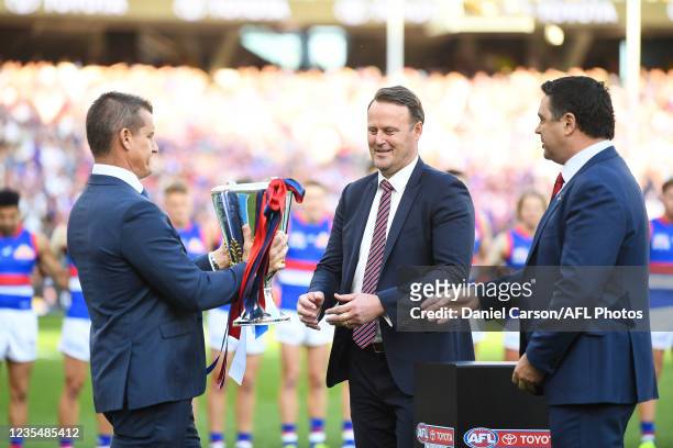 Glen Jakovich hands the Premiership Cup over during the 2021 Toyota AFL Grand Final match between the Melbourne Demons and the Western Bulldogs at...