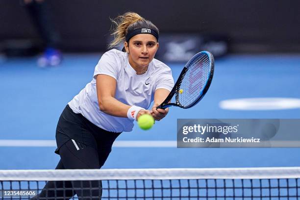 Sania Mirza from India plays a backhand against Eri Hozumi from Japan and Makoto Ninomiya from Japan in Semifinal Doubles match during Day 6 of the...