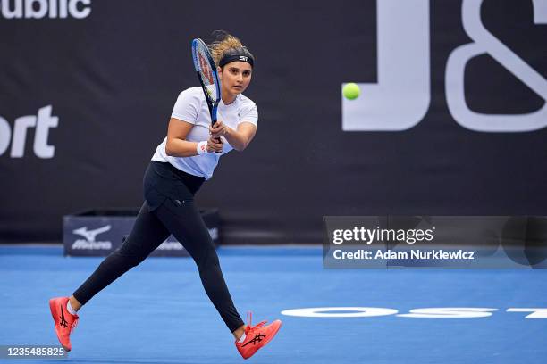 Sania Mirza from India plays a backhand against Eri Hozumi from Japan and Makoto Ninomiya from Japan in Semifinal Doubles match during Day 6 of the...