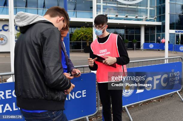 Member of staff carries out COVID-19 checks outside the King Power Stadium before the Premier League match between Leicester City and Burnley at King...