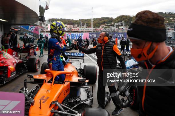 McLaren's British driver Lando Norris celebrates taking the pole position after the qualifying session for the Formula One Russian Grand Prix at the...