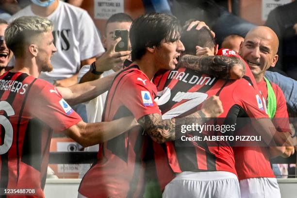 Milan's Belgian midfielder Alexis Saelemaekers and AC Milan's Italian midfielder Sandro Tonali congratulate AC Milan's Italian forward Daniel Maldini...