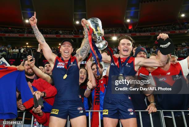 James Harmes and Bayley Fritsch of the Demons celebrate with fans after the 2021 Toyota AFL Grand Final match between the Melbourne Demons and the...