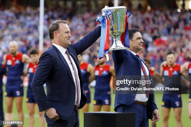 Chris Grant and Garry Lyon hold up the premiership cup during the 2021 Toyota AFL Grand Final match between the Melbourne Demons and the Western...