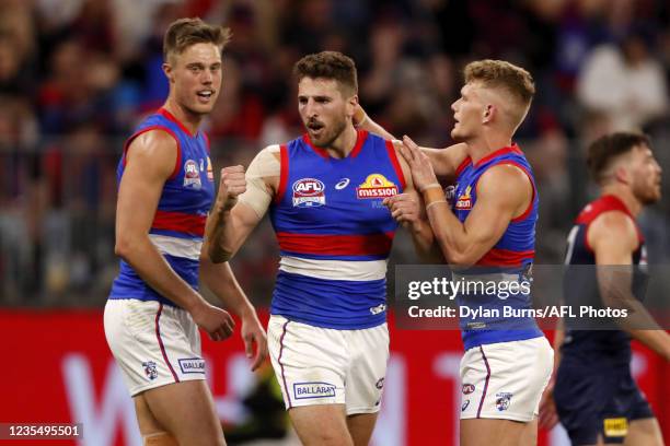 Marcus Bontempelli of the Bulldogs celebrates a goal with Josh Schache of the Bulldogs and Adam Treloar of the Bulldogs during the 2021 Toyota AFL...