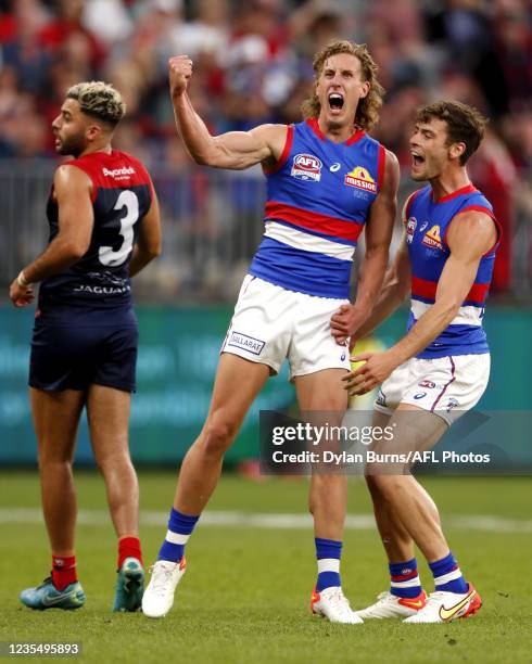 Aaron Naughton of the Bulldogs celebrates a goal with Josh Dunkley of the Bulldogs during the 2021 Toyota AFL Grand Final match between the Melbourne...