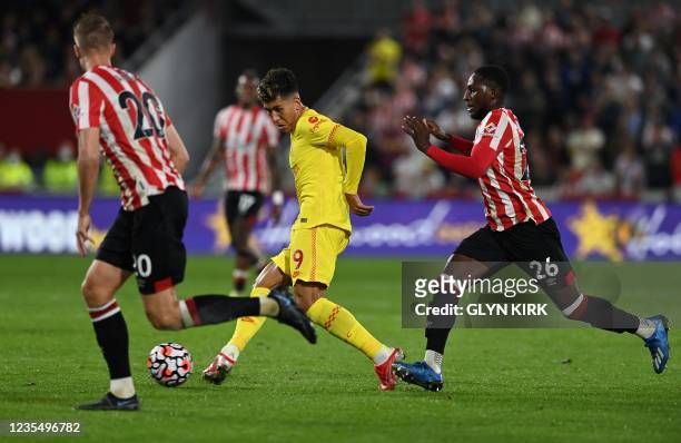 Liverpool's Brazilian midfielder Roberto Firmino crosses the ball during the English Premier League football match between Brentford and Liverpool at...