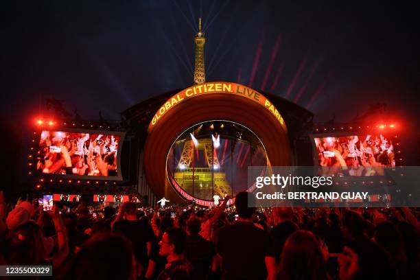 Attendees enjoy a 'Global Citizen Live' concert in Paris on September 25, 2021. - From Billie Eilish in New York to BTS in Seoul and Elton John in...