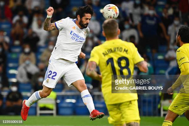 Real Madrid's Spanish midfielder Isco heads the ball during the Spanish League football match between Real Madrid and Villarreal CF at the Santiago...
