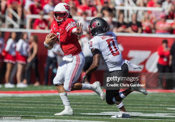 Cam Rising of the Utah Utes rushes out of the pocket under pressure from Jaylen Watson of the Washington State Cougars during their game September...