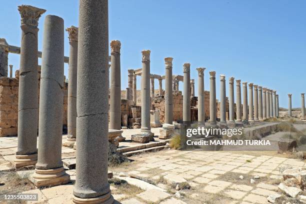 Picture shows a view of black granite Corynthian columns lining a temple courtyad next to the theatre in the ancient Roman city of Leptis Magna, near...