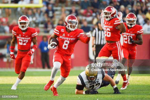 Houston Cougars cornerback Marcus Jones guides his blockers during a first half punt return for a touchdown during the football game between the Navy...