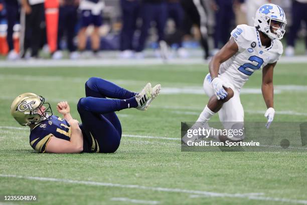 Don Chapman of the North Carolina Tar Heels collides with David Shanahan of the Georgia Tech Yellow Jackets while punting during the Saturday evening...