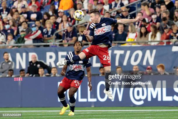 New England Revolution midfielder Tommy McNamara rises to head the ball during a match between the New England Revolution and Orlando City SC on...