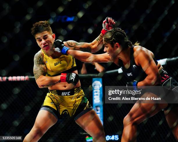 Cynthia Cavillo punches Jéssica Andrade during the first round of their Flyweight fight during UFC 266 at T-Mobile Arena on September 25, 2021 in Las...