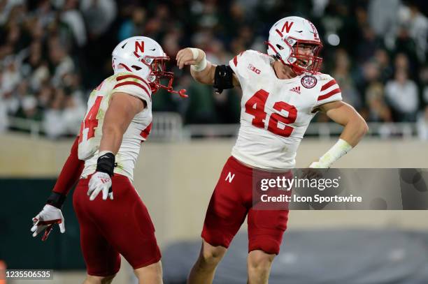 Nebraska Cornhuskers linebackers Nick Henrich linebacker Garrett Nelson celebrate a sack during a college football game between the Michigan State...