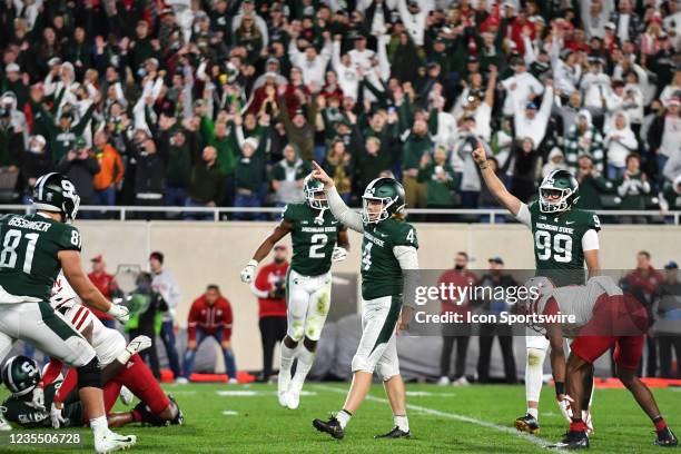 Michigan State placekicker celebrates his game winning field goal in overtime of a college football game between the Michigan State Spartans and the...