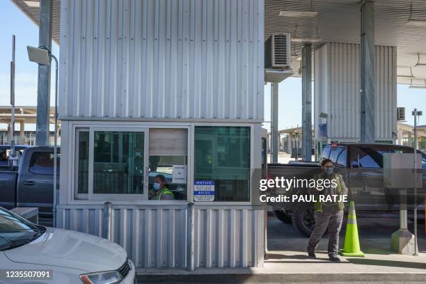 Toll booth operators are pictured at the Del Rio Port of Entry after it reopened following closure for over a week due to an influx of migrants,...