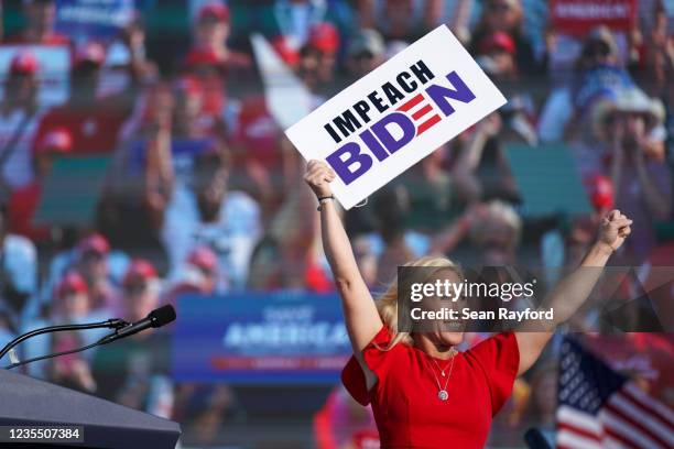 Rep. Marjorie Taylor Greene holds a sign that reads Impeach Biden at a rally featuring former US President Donald Trump on September 25, 2021 in...