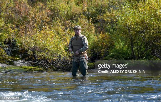 In this undated picture, made available on September 26, 2021 by Sputnik news agency, Russian President Vladimir Putin fishes in the taiga. - In...