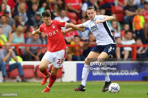 Joe Lolley of Nottingham Forest battles with Murray Wallace of Millwall during the Sky Bet Championship match between Nottingham Forest and Millwall...