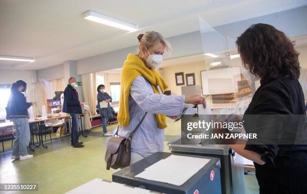 Woman casts her vote at a polling station in Berlin on September 26 during Berlin State and German federal elections.
