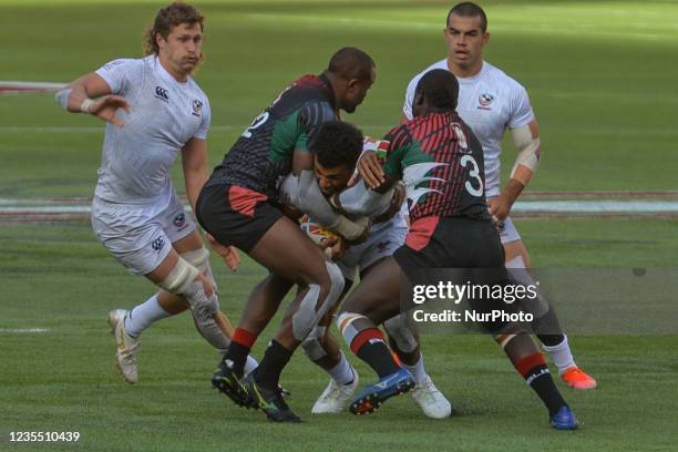 Gavan D'Amore of USA tacled by Willy Ambaka and Alvin Otieno of Kenya during Kenya 7S vs USA 7S, HSBC World Rugby Seven Series match at the...