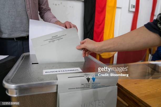 Voter casts his ballot at a polling station during federal parliamentary elections in Berlin, Germany, on Sunday, Sept. 26, 2021. German voters are...