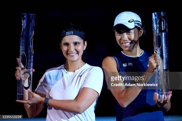 Winners Sania Mirza of India and Shuai Zhang of China pose with their trophies during the awarding ceremony following the Doubles Final on Day 7 of...