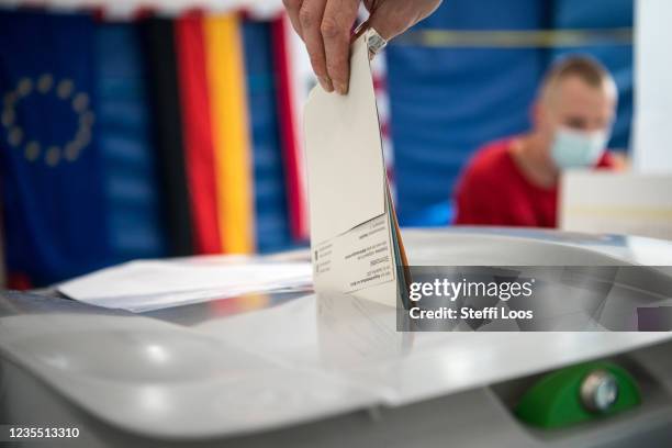 Voters cast their ballots in federal parliamentary elections on September 26, 2021 in Berlin, Germany. Voters are going to the polls nationwide today...