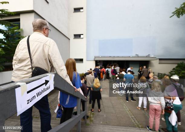 German voters wait in line as they arrive at a polling station during a Parliamentary election, in Berlin, Germany on September 26, 2021. Germans are...