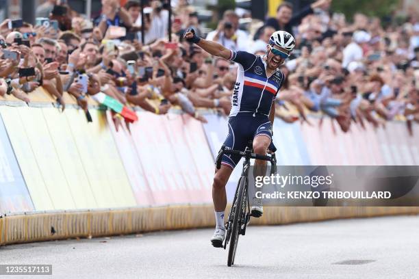 France's Julian Alaphilippe celebrates as he crosses the finish line to win the men's elite cycling road race 3km from Antwerp to Leuven, on the...