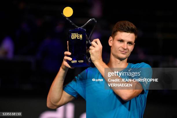 Poland's Hubert Hurkacz celebrates his victory over Spain's Pablo Carreno Busta, posing with the trophy after winning the ATP Moselle Open final...