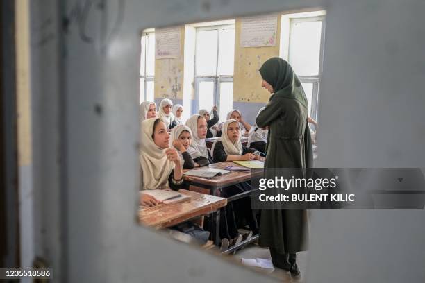Afghan girls attend a class in a school in Kandahar on September 26, 2021.
