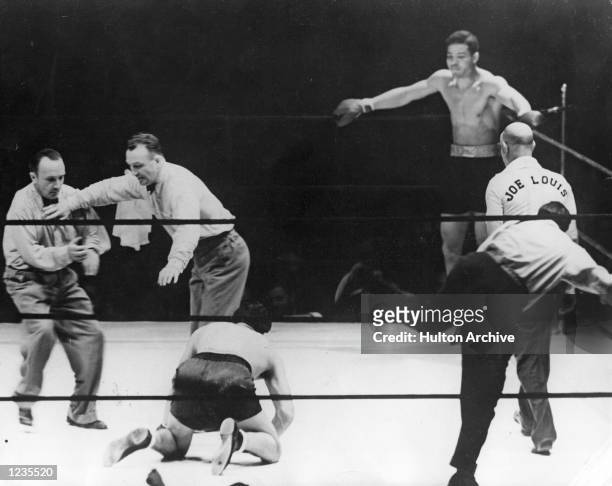 Max Schmeling the former champion is floored by Joe Louis during their World Heavyweight bout on June 22, 1938 at Yankee Stadium in the Bronx, New...
