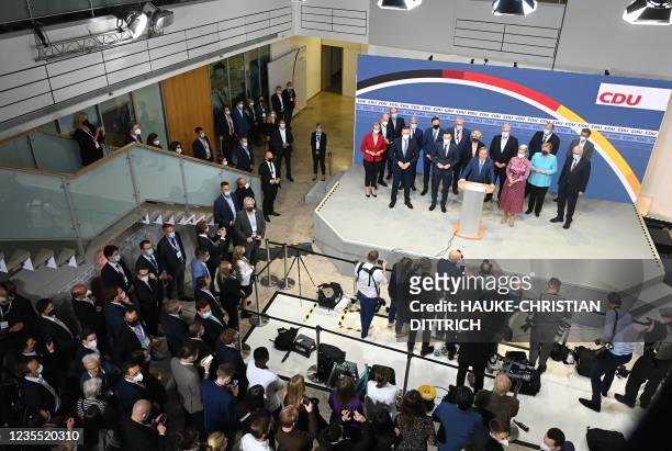 Christian Democratic Union leader and Chancellor candidate Armin Laschet adresses the audience on stage at the CDU headquarters after the estimates...
