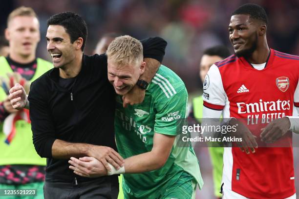 Mikel Arteta manager of Arsenal celebrates the win with Aaron Ramsdale and Ainsley Maitland-Niles during the Premier League match between Arsenal and...