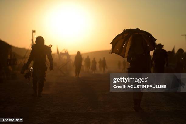 People attend Wasteland Weekend Festival at the Mojave desert in Edwards, California on September 25, 2021. - The organizers require all festival...