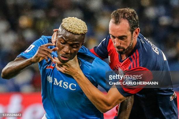 Cagliari's Uruguayan defender Diego Godin holds back Napoli's Nigerian forward Victor Osimhen by the neck during the Italian Serie A between Napoli...