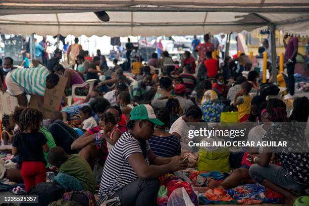 Haitian migrants remain outside a migrant shelter where they await their immigration resolution, in Monterrey, Mexico, on September 26, 2021. -...