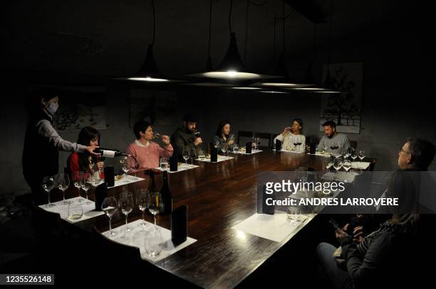 Tourists taste wine at the Zuccardi Valle de Uco winery in Valle de Uco, San Carlos department, Mendoza province, Argentina, on September 26, 2021. -...