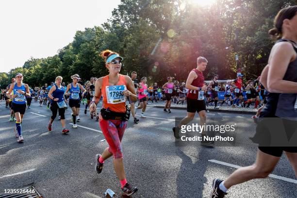 Participant runs as thousands of people participate in 47. BMW at Bundesstrasse at Berlin Marathon on September 26, 2021 in Berlin, Germany. The...