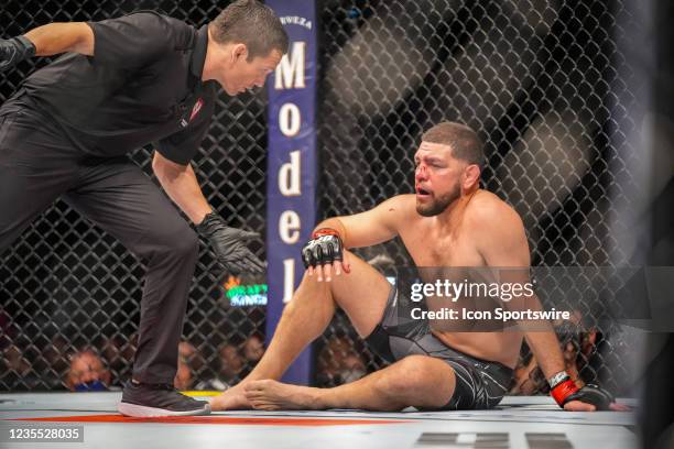 Nick Diaz rests on the canvas following his knockdown by Robbie Lawler in their middleweight fight during UFC 266 on September 25 at T-Mobile Arena...
